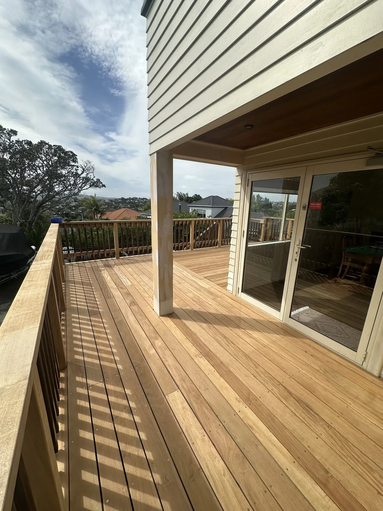 Covered timber deck with balustrade and sliding doors