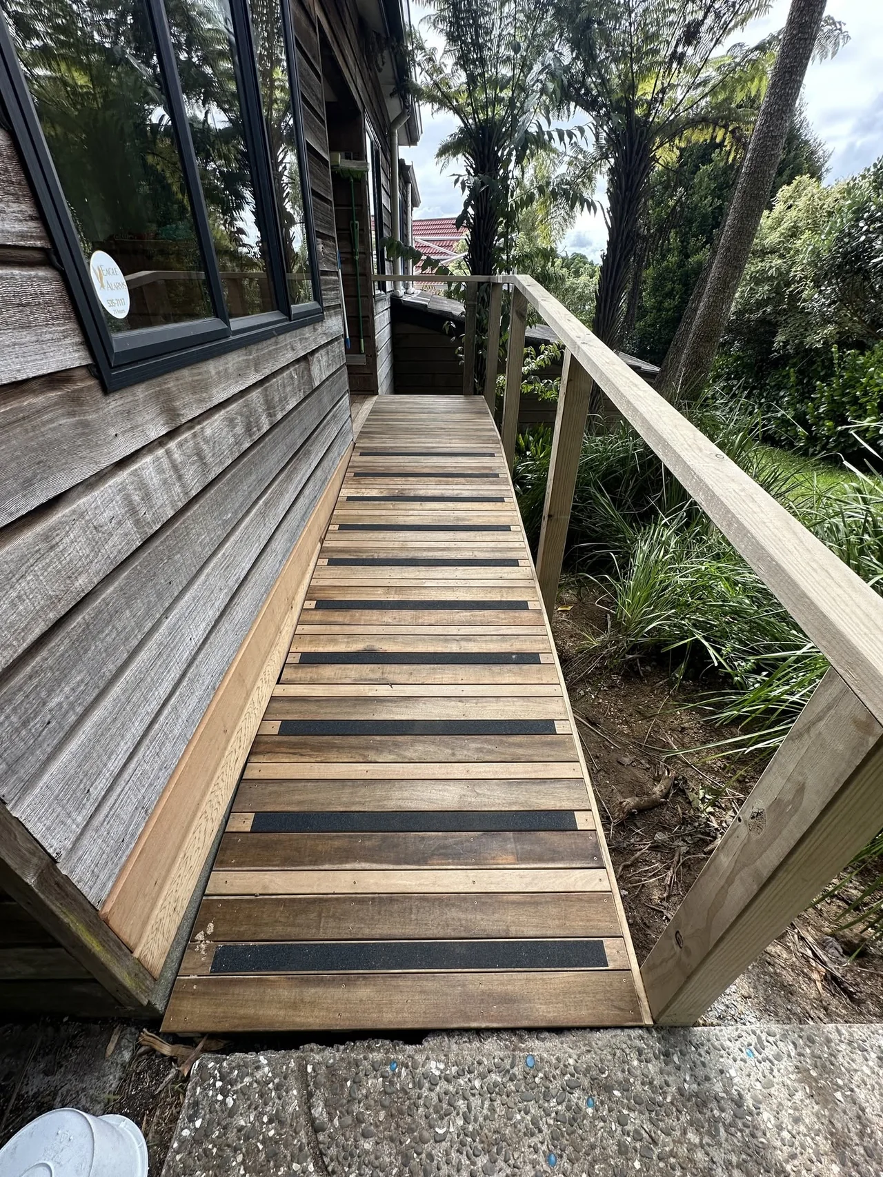 Timber garden walkway and handrail alongside a home