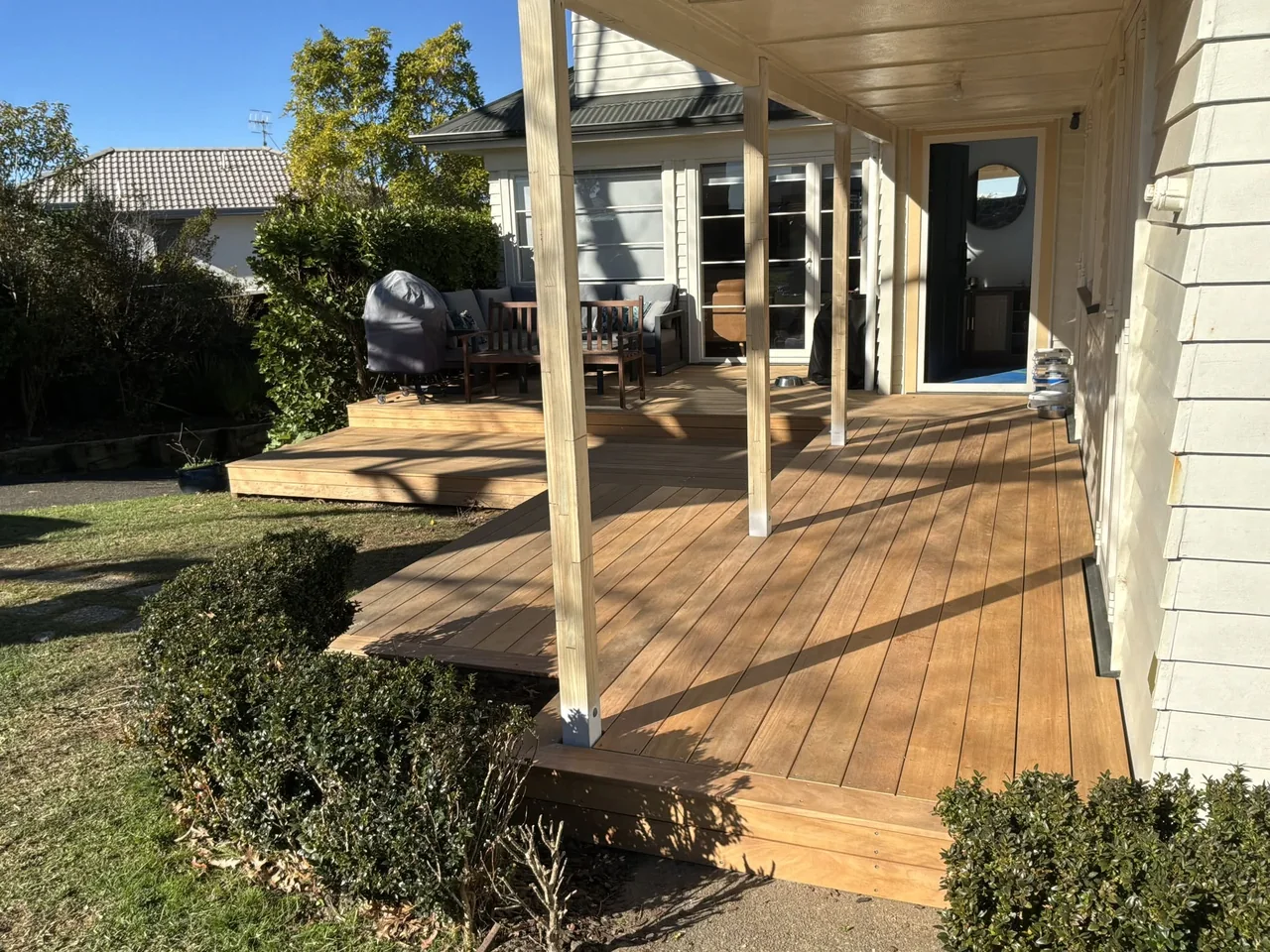 Timber verandah deck and steps leading into a garden
